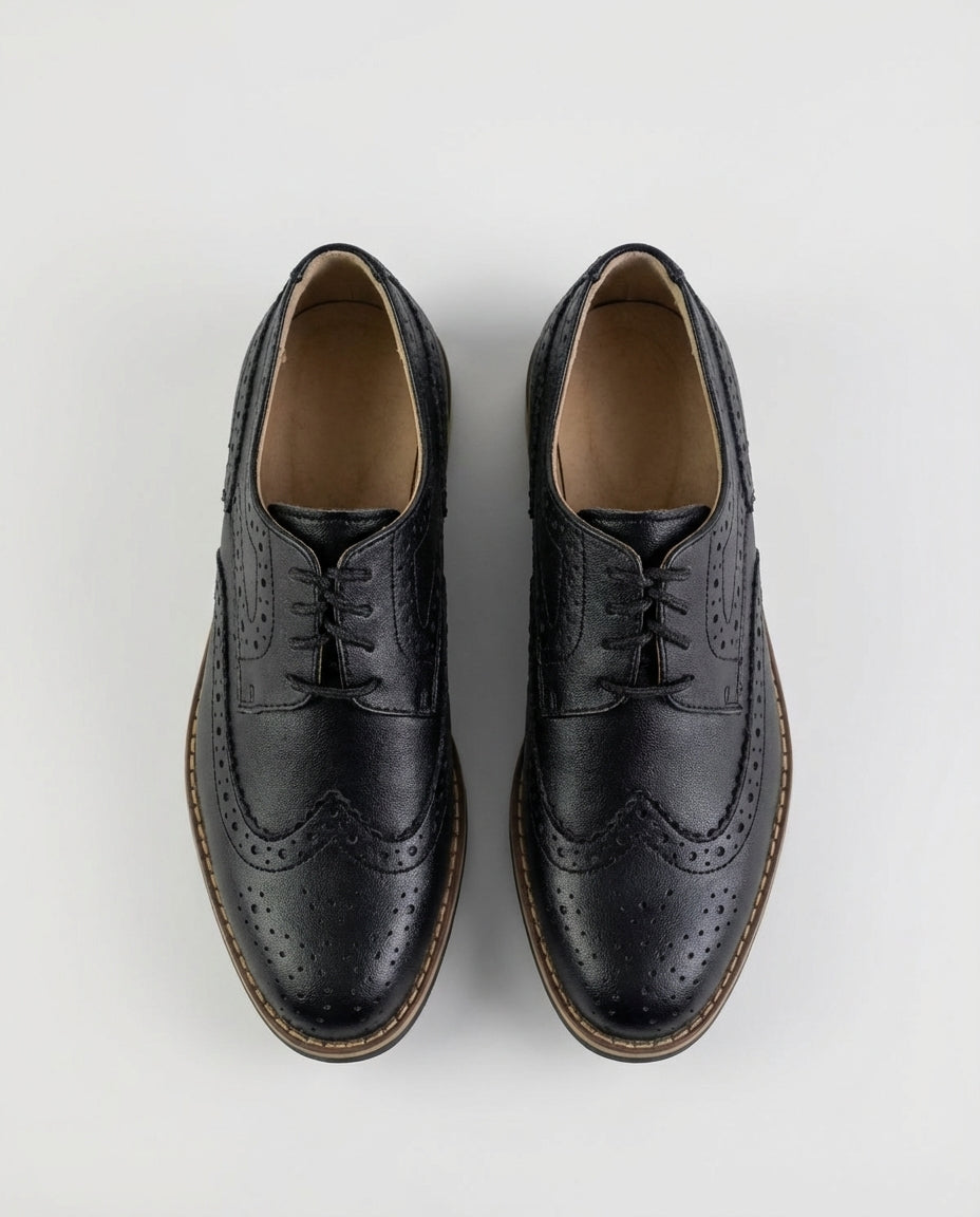 Boys classic black wingtip brogue shoe — sole view