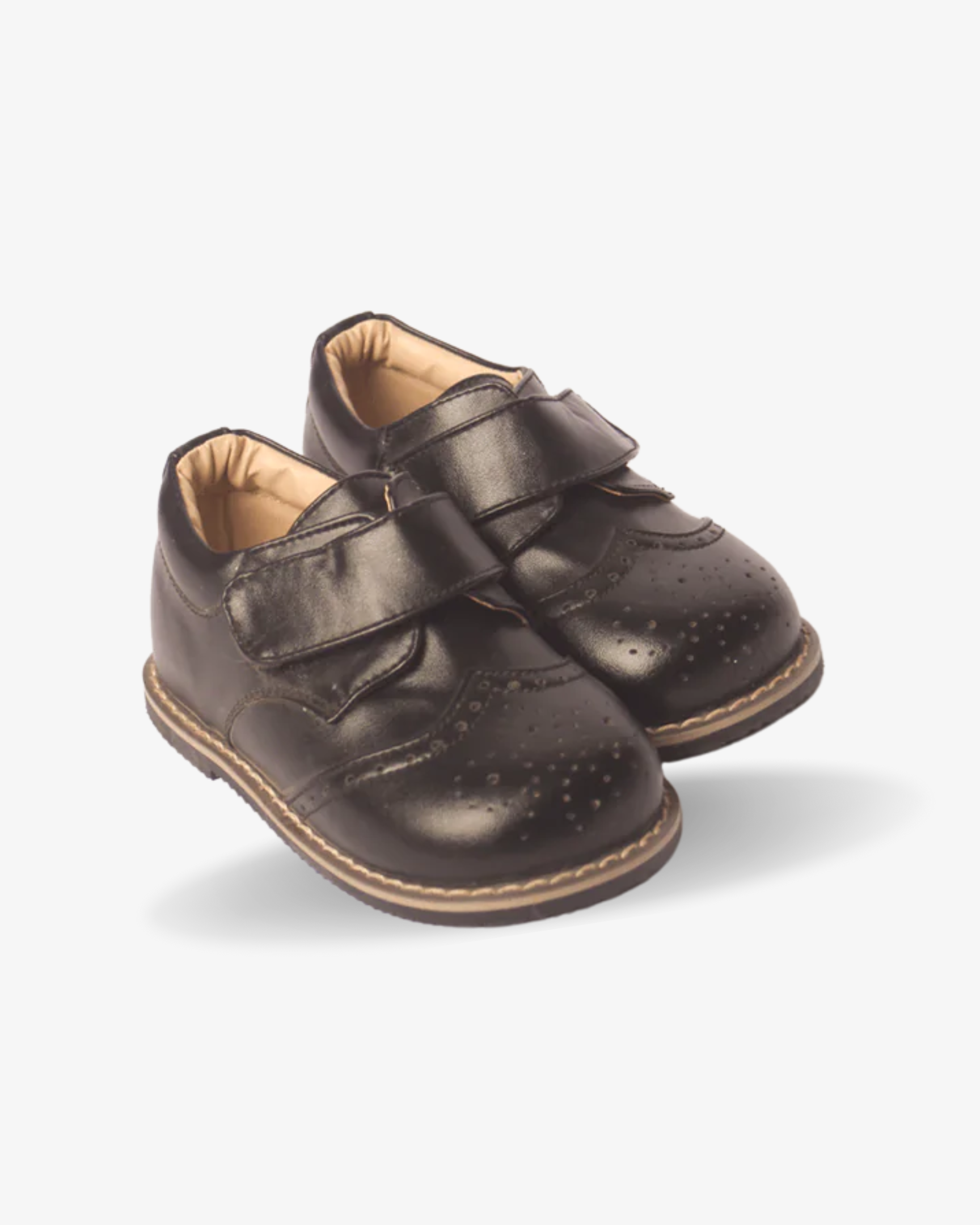 Boys classic black strap wingtip shoe — three-quarter angle
